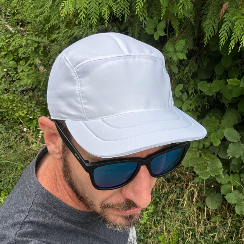 Man wearing a white 5-panel Packlite Hat